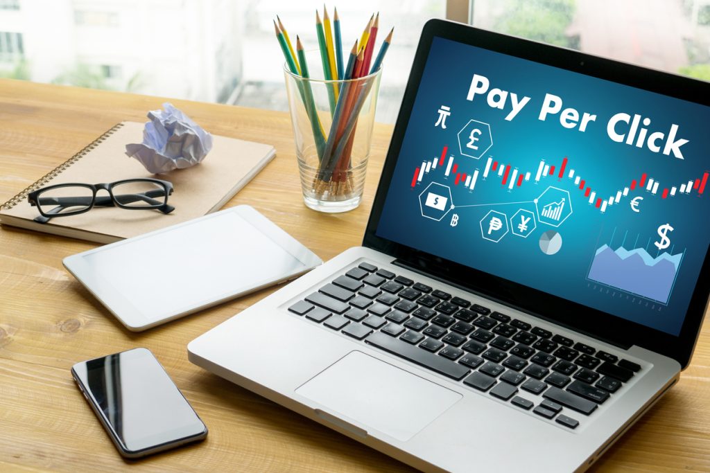 Laptop on table showing PPC graphs
