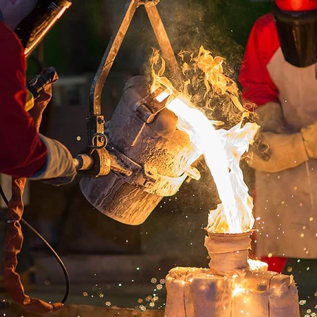 people melting something with a big fire