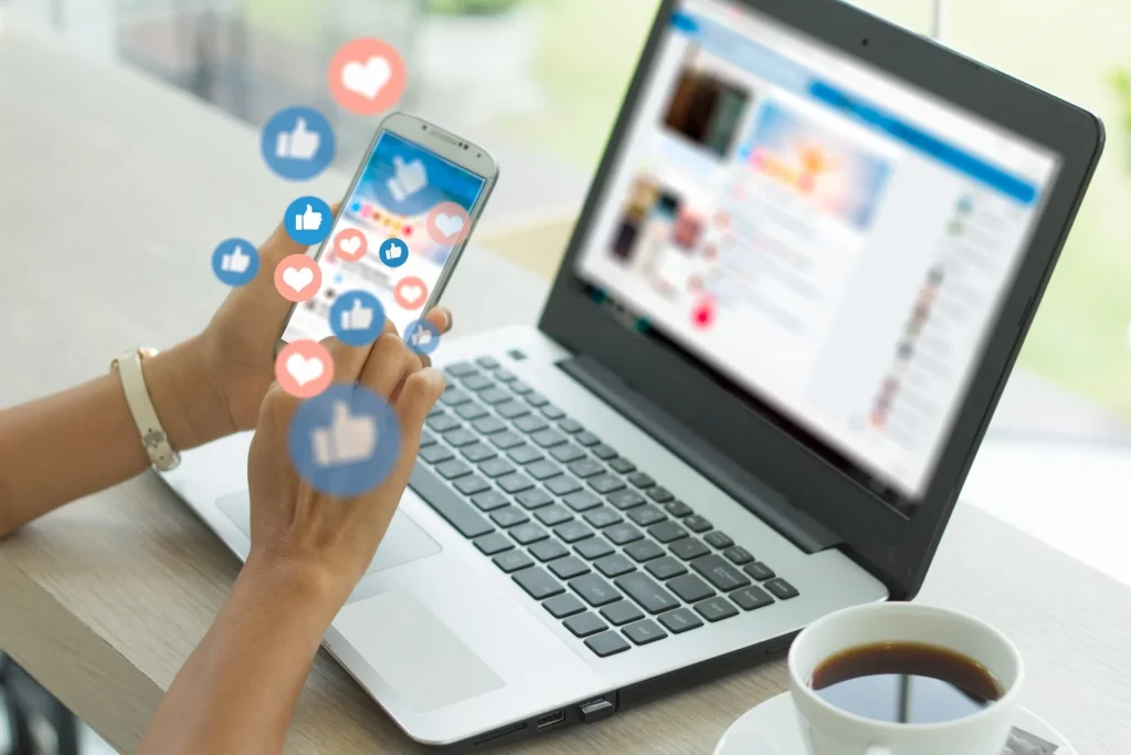 phone and a laptop showing a social media platform