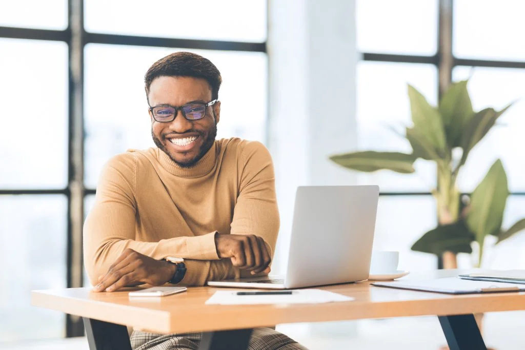 business man smiling in a work desk