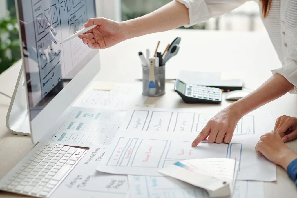 people comparing draws from a paper to the computer
