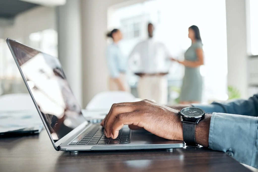 man hands typing in a laptop