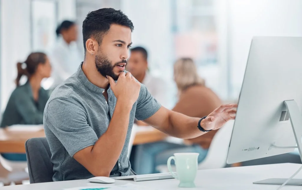 man working in an office in front of a pd