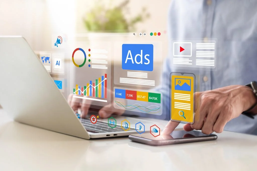 person looking into ads metrics in his phone and laptop