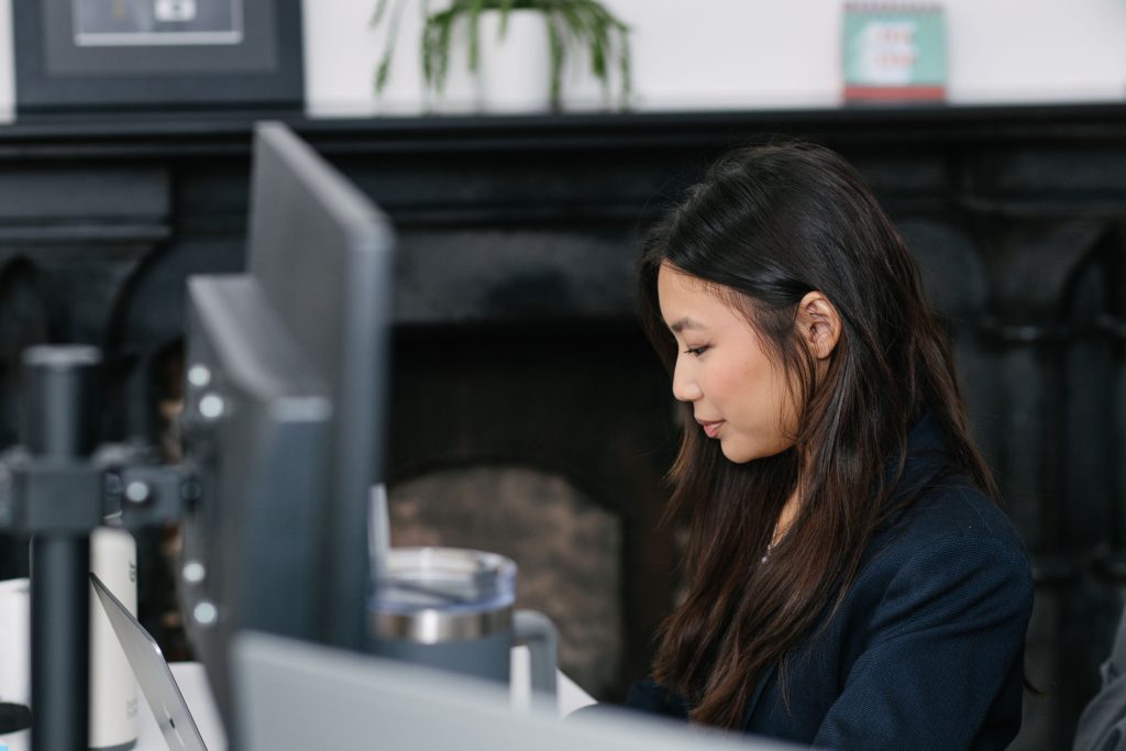 woman working in an office with long hair