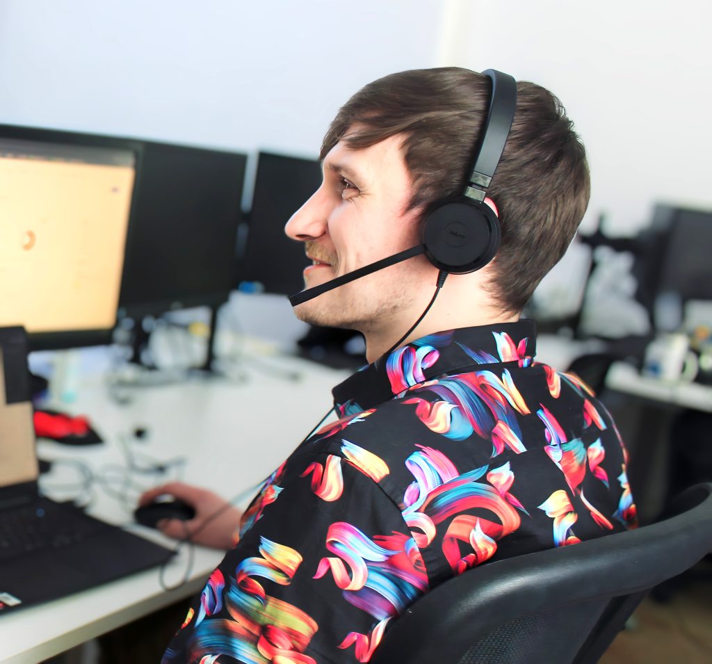man wotking in an office with headphones