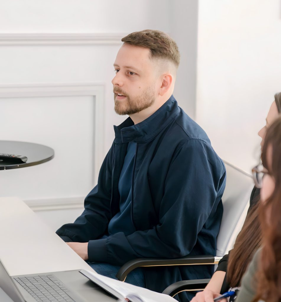 Man in an office with a blue jacket