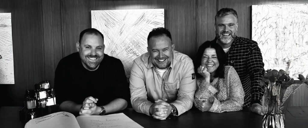 group of people smiling in black and white