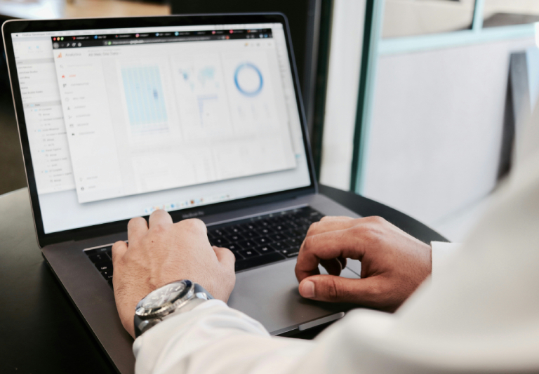person looking into analytics in a laptop