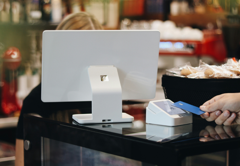 person paying by card in a shop